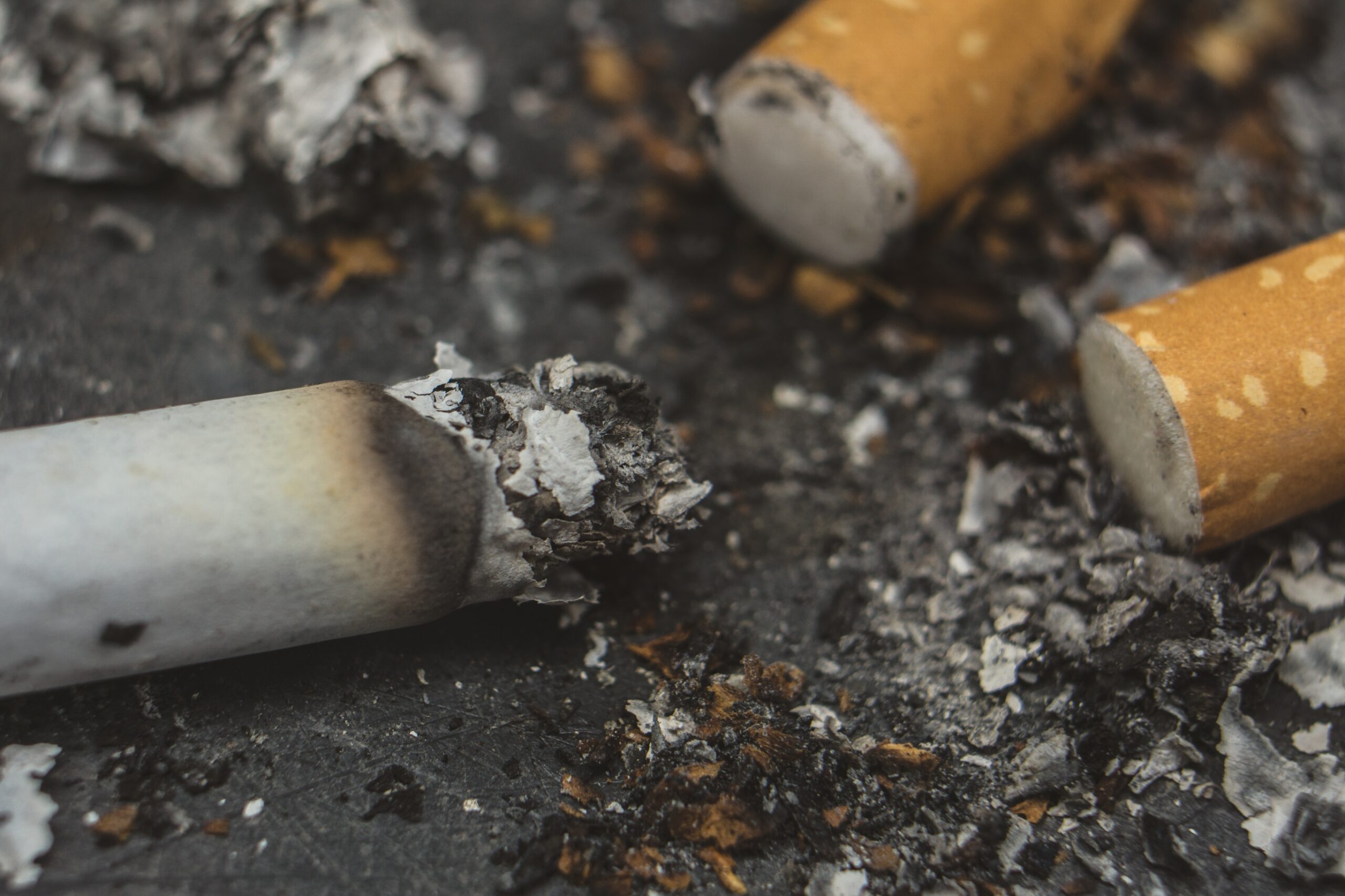 Cigarette.Closeup cigarette and cigarette butt on the floor.World No Tobacco Day Concept Stop Smoking.